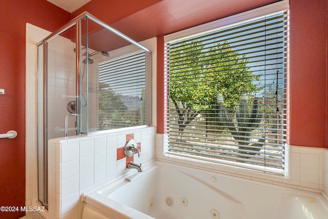 bathroom featuring independent shower and bath