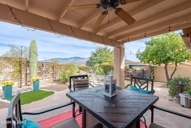 view of patio / terrace featuring a mountain view and ceiling fan