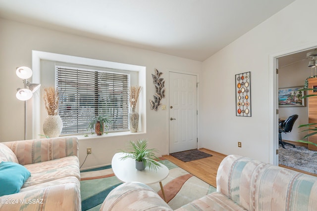 living room featuring light hardwood / wood-style flooring and lofted ceiling