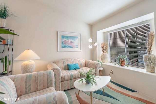 carpeted living room featuring vaulted ceiling