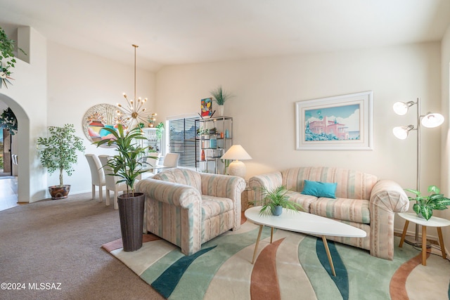 living room featuring light carpet, a chandelier, and vaulted ceiling