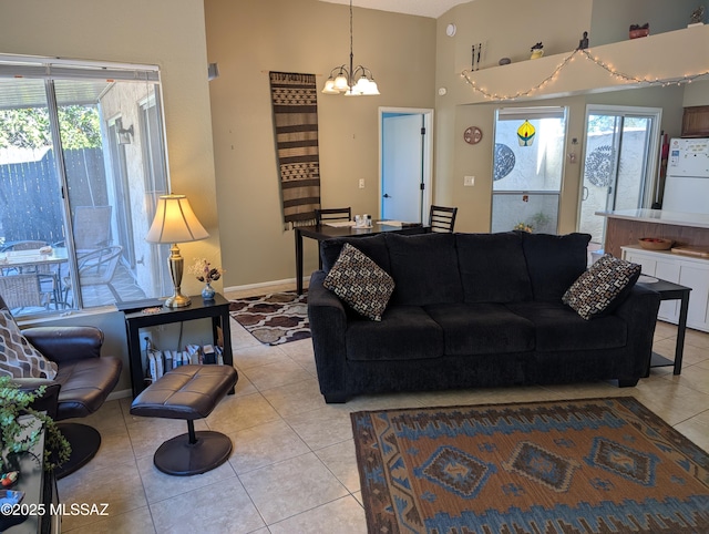 living room with light tile patterned floors and a chandelier