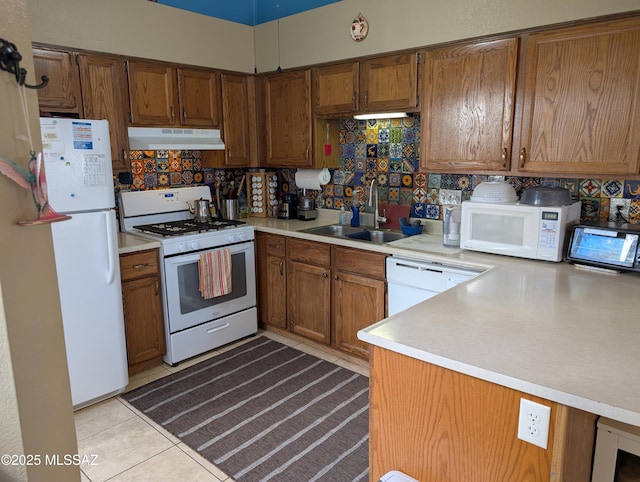 kitchen with sink, kitchen peninsula, white appliances, decorative backsplash, and light tile patterned floors