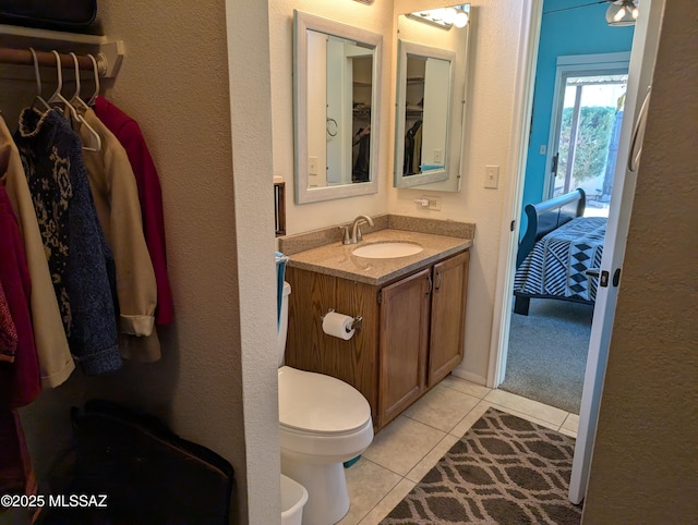 bathroom with tile patterned floors, vanity, and toilet