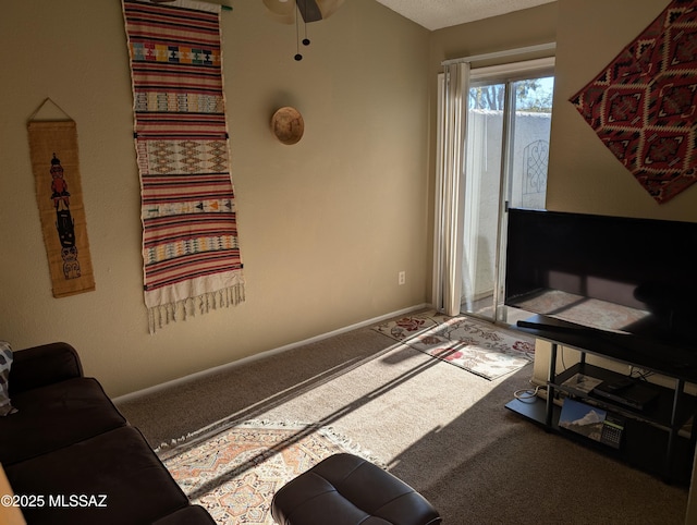 carpeted living room featuring ceiling fan