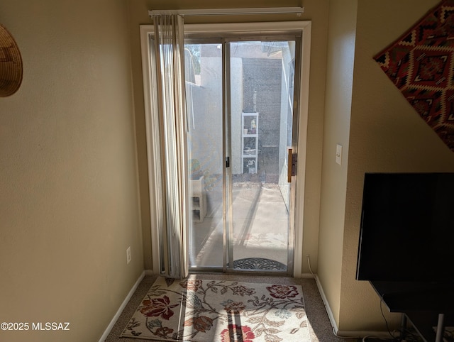 doorway to outside featuring carpet floors