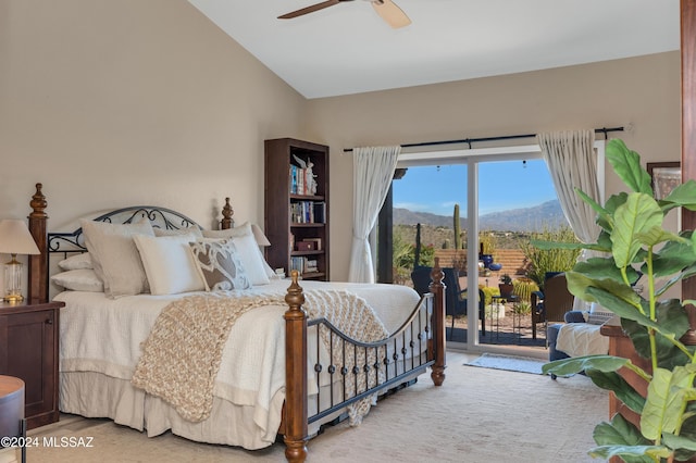 bedroom with access to exterior, ceiling fan, carpet floors, vaulted ceiling, and a mountain view