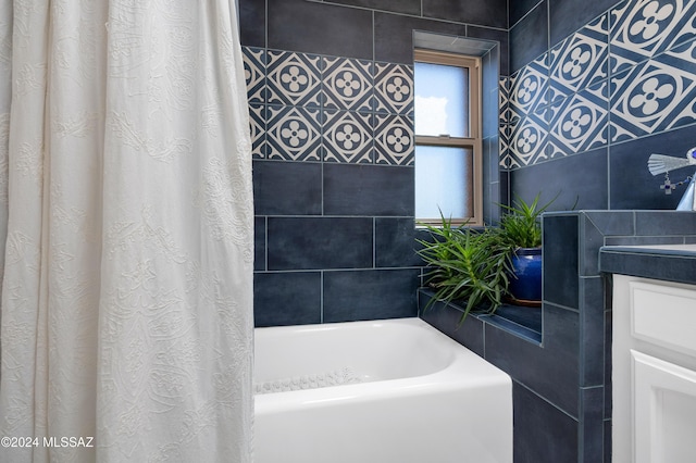 full bath featuring a shower with curtain, vanity, and a tub to relax in