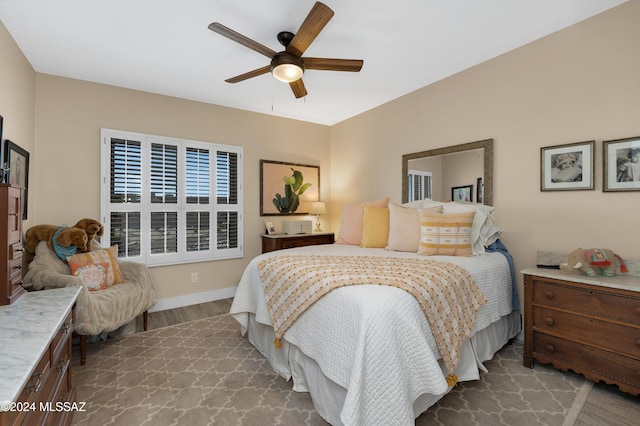 bedroom with wood finished floors, baseboards, and ceiling fan