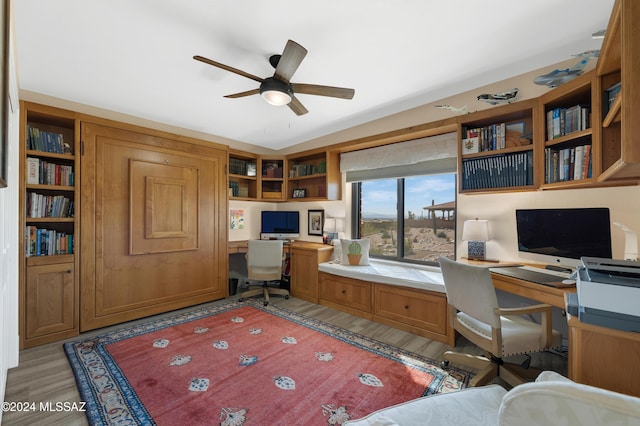 home office featuring a ceiling fan and built in desk