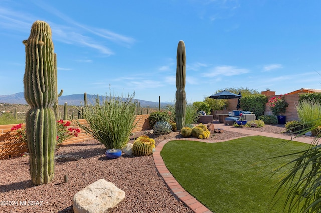 view of yard with a mountain view, a patio area, and fence