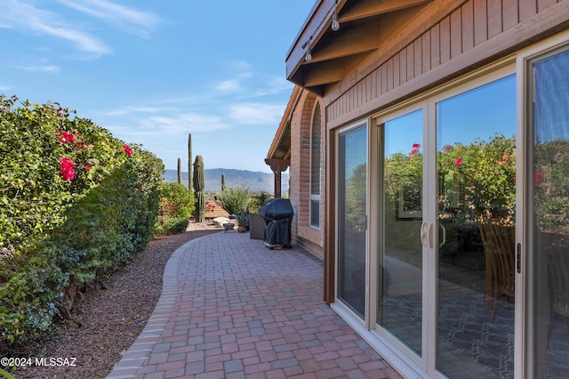 view of patio with area for grilling and a mountain view