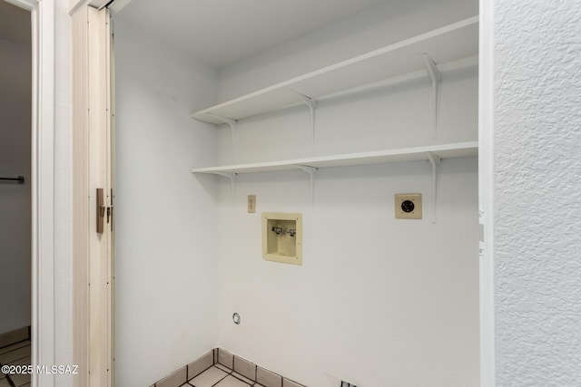 laundry room with hookup for a washing machine, electric dryer hookup, tile patterned floors, and laundry area