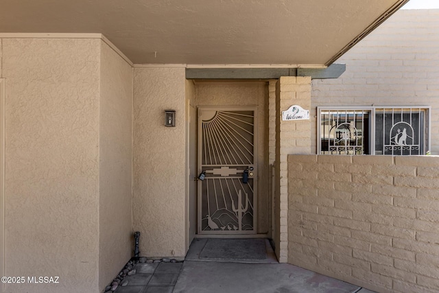 property entrance featuring stucco siding