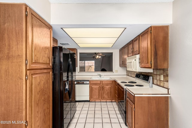 909 N Capron Pl, Tucson, AZ 85710 - kitchen featuring white appliances, light countertops, ceiling fan, light tile patterned floors, and a sink