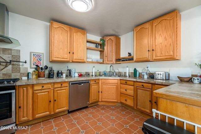 kitchen with appliances with stainless steel finishes, sink, and wall chimney exhaust hood