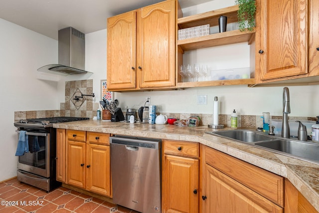 kitchen with appliances with stainless steel finishes, tile patterned flooring, wall chimney exhaust hood, and sink