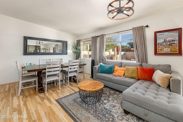 living room featuring an inviting chandelier and hardwood / wood-style floors