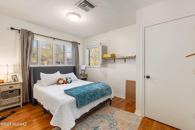 bedroom with hardwood / wood-style flooring