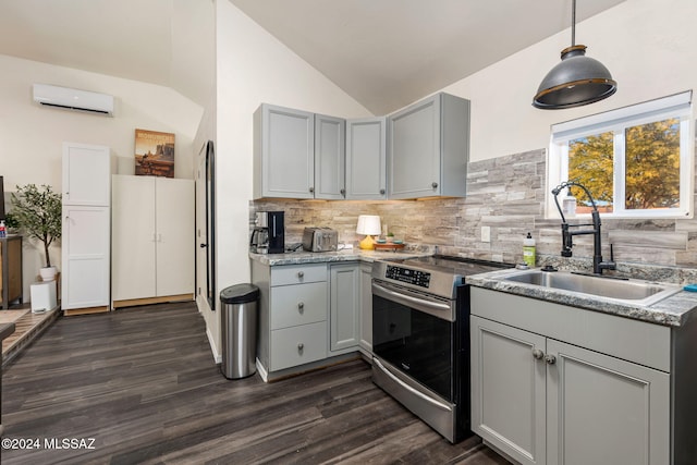kitchen with stainless steel range with electric cooktop, backsplash, dark wood-type flooring, gray cabinetry, and pendant lighting