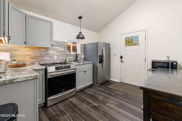 kitchen with appliances with stainless steel finishes, hanging light fixtures, gray cabinetry, and dark hardwood / wood-style flooring