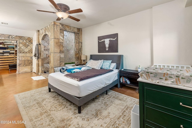 bedroom featuring ceiling fan and light wood-type flooring