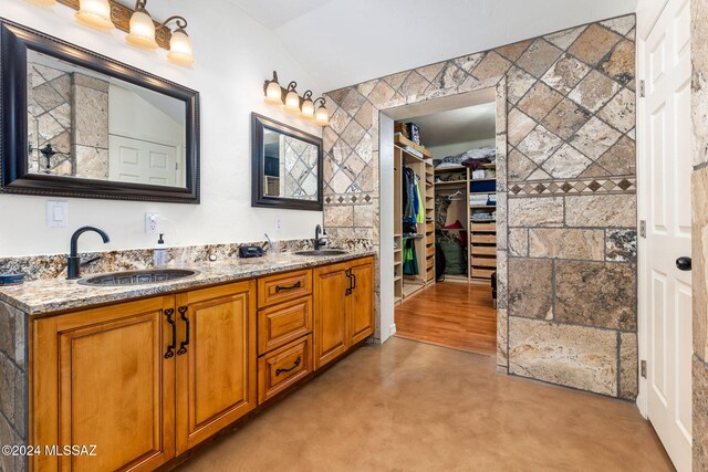 bathroom with concrete flooring and vanity