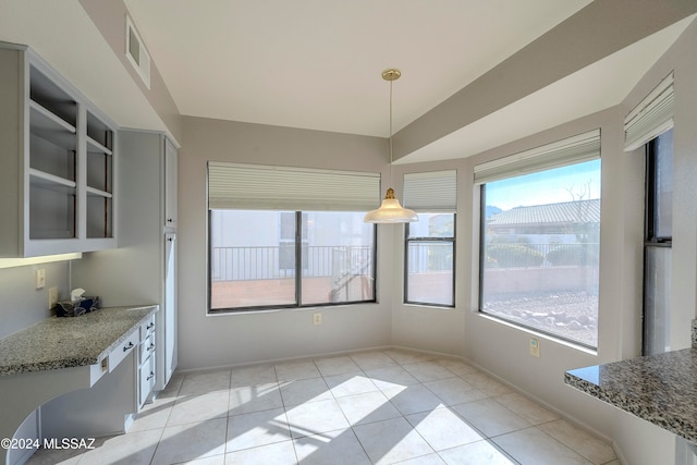 unfurnished dining area featuring light tile patterned floors