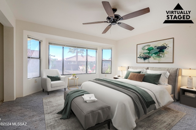 carpeted bedroom with multiple windows and ceiling fan