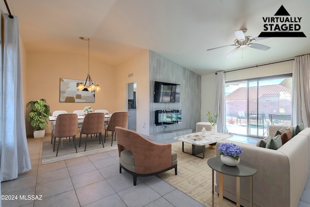 tiled living room with lofted ceiling and ceiling fan with notable chandelier