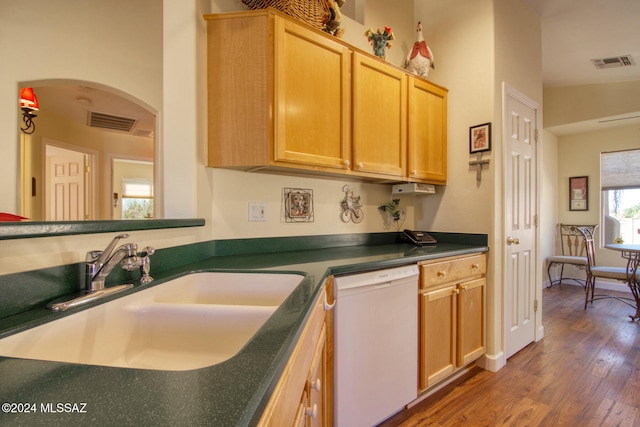 kitchen featuring light brown cabinets, white dishwasher, dark wood-type flooring, and sink