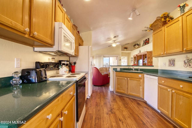 kitchen with white appliances, ceiling fan, sink, dark hardwood / wood-style floors, and lofted ceiling