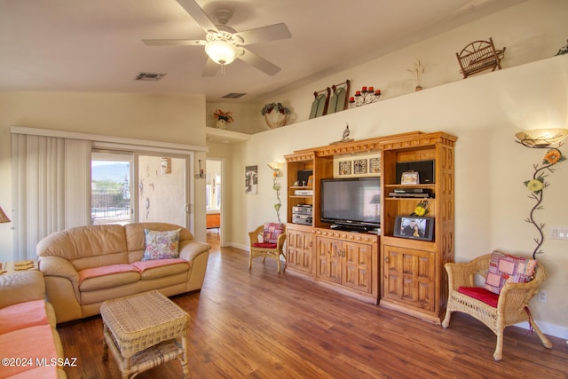 living room featuring ceiling fan, dark hardwood / wood-style floors, and vaulted ceiling