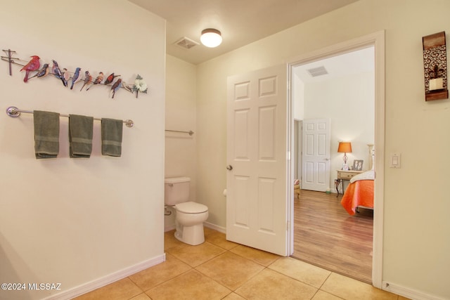 bathroom with hardwood / wood-style flooring and toilet