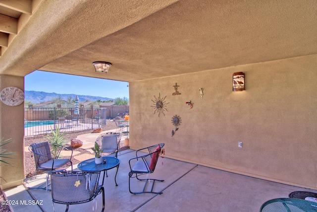 view of patio featuring a mountain view and a community pool