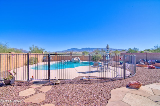 view of swimming pool with a mountain view and a patio