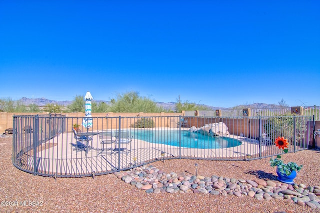 view of pool featuring a mountain view and a patio area