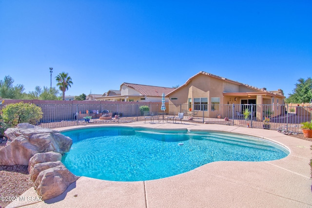 view of swimming pool featuring a patio area