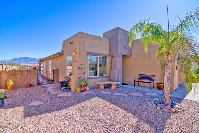 rear view of property featuring a mountain view