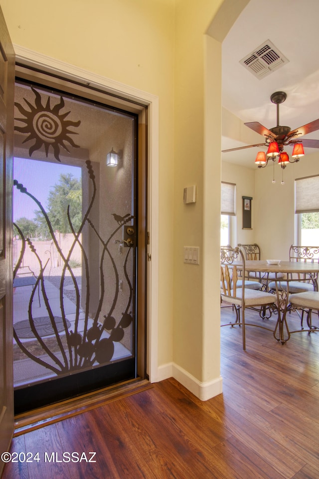 foyer entrance with ceiling fan and wood-type flooring