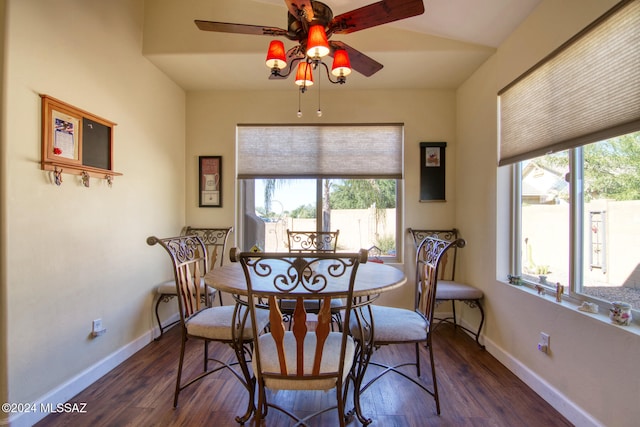 dining room with ceiling fan, dark hardwood / wood-style flooring, and lofted ceiling