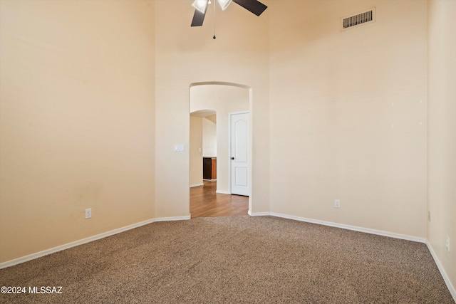 carpeted spare room with ceiling fan