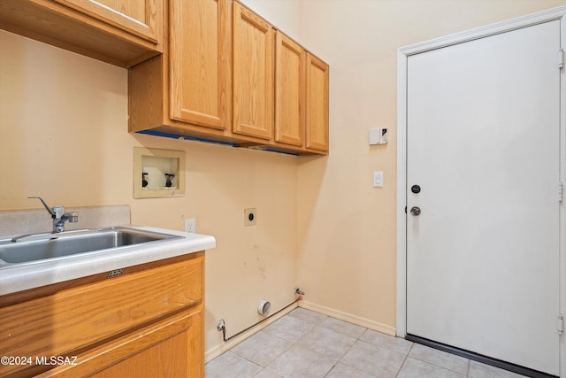 washroom featuring gas dryer hookup, hookup for a washing machine, cabinets, light tile patterned flooring, and hookup for an electric dryer