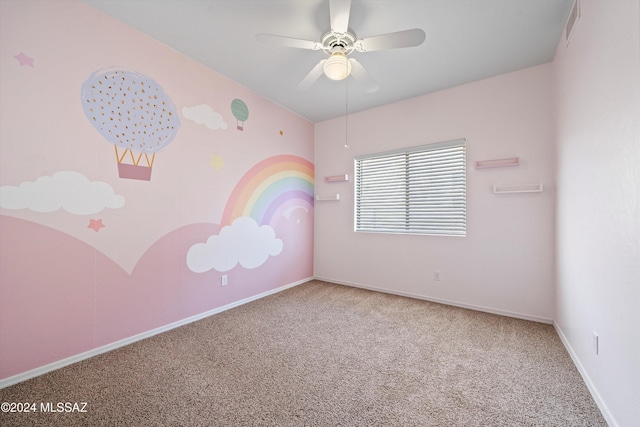 carpeted empty room featuring ceiling fan