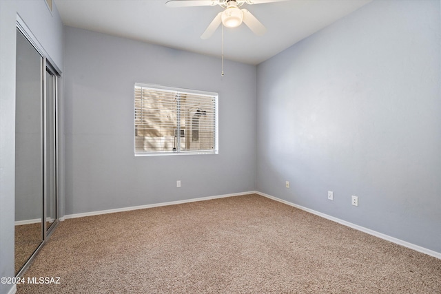 unfurnished bedroom with carpet floors, ceiling fan, and a closet