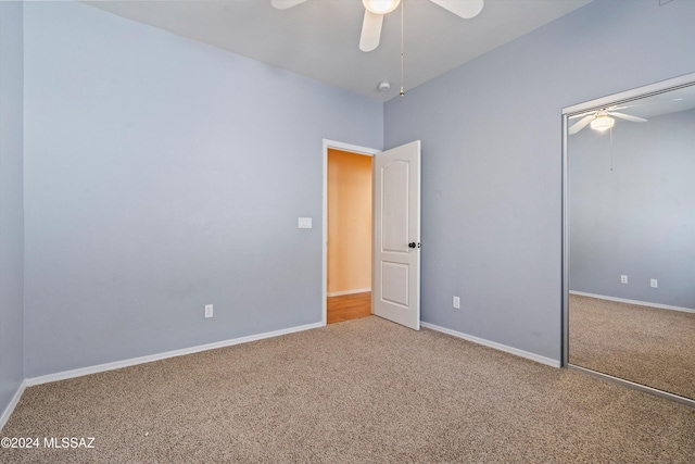 unfurnished bedroom with ceiling fan, carpet floors, and a closet