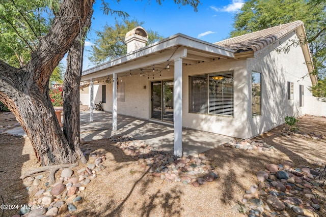 back of property with a patio