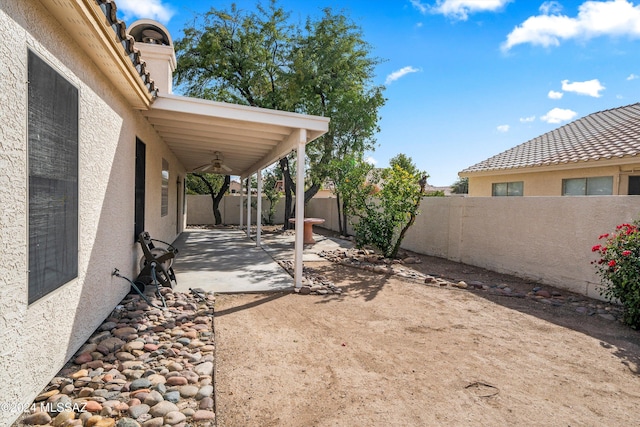 view of yard with a patio area and ceiling fan