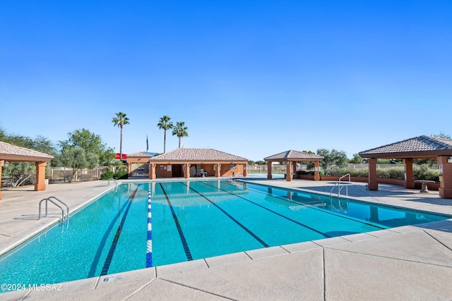 view of swimming pool with a gazebo and a patio area