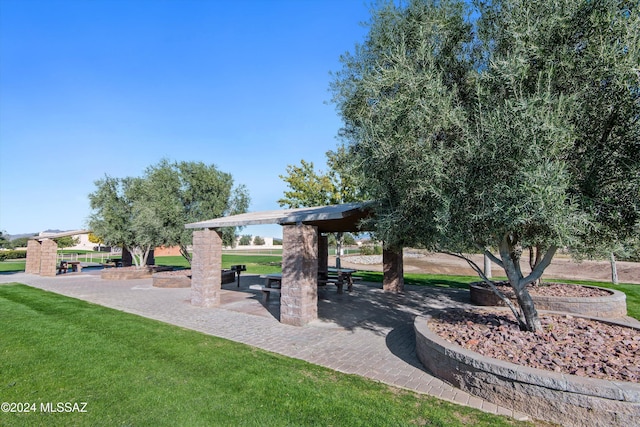 view of community featuring a yard and a patio